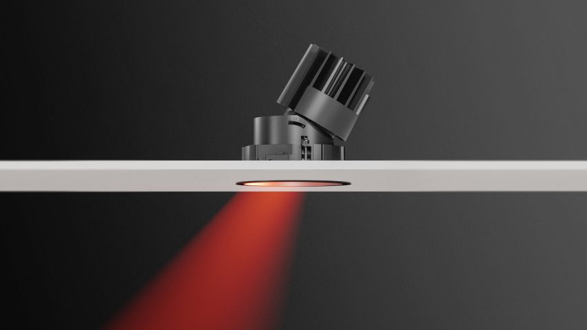 Tilted downlight recessed behind a white board producing a red light