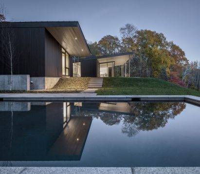 Swimming pool at blackened wood Roxbury House