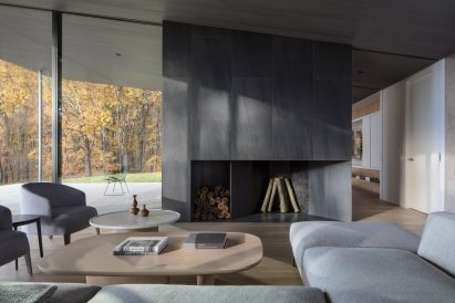 Neutral interiors within living space of charred wood house by Desai Chai Architects
