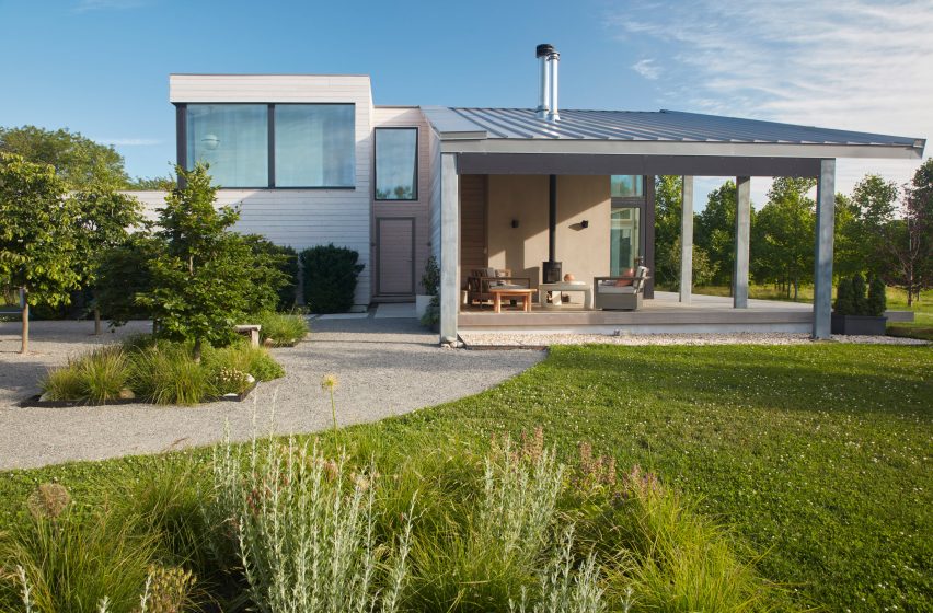 Two-storey home with a large porch with a sloping room that overlooks a grassy garden