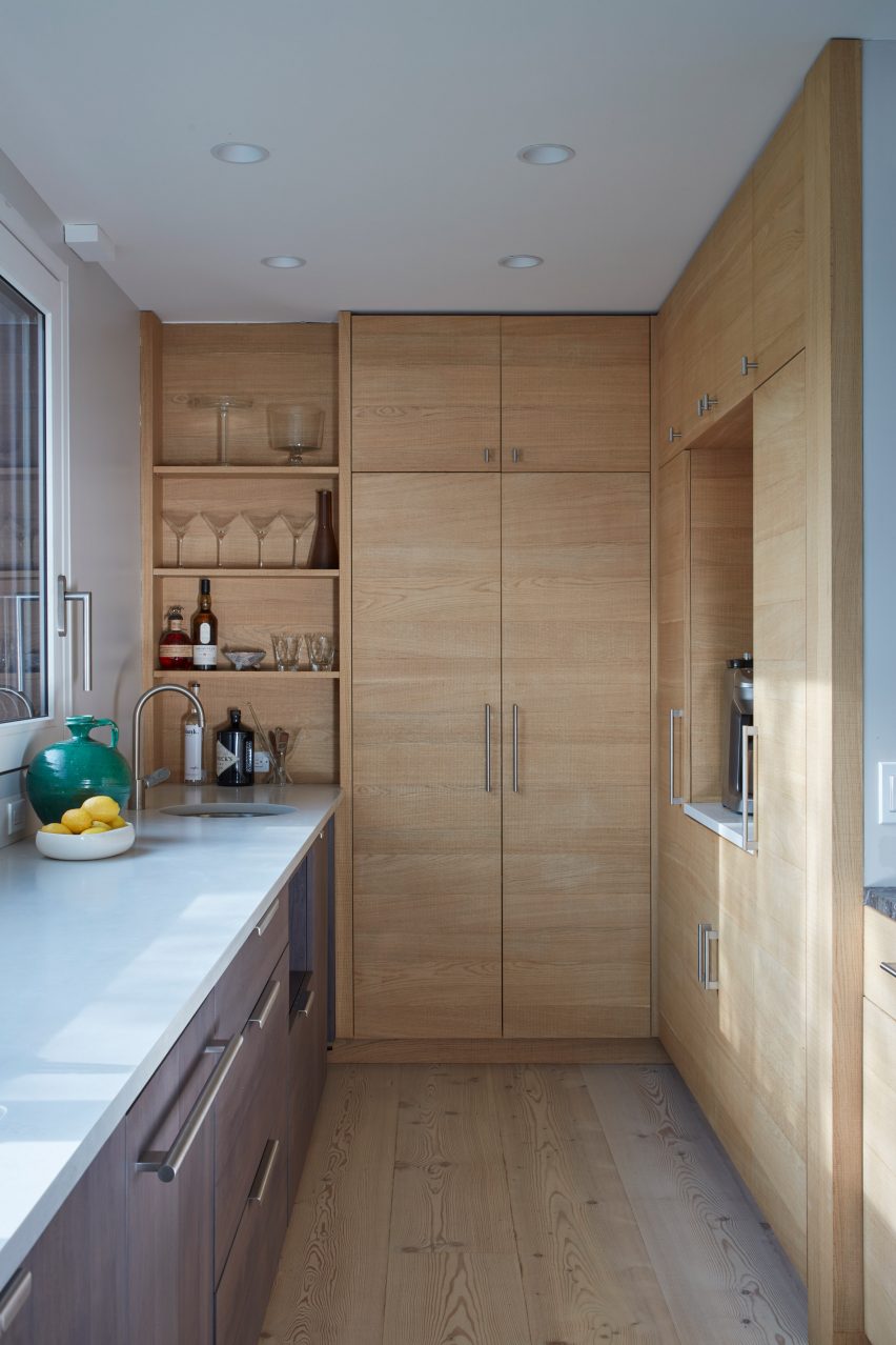 Utility room with white worktops and wooden built-in wall storage furniture