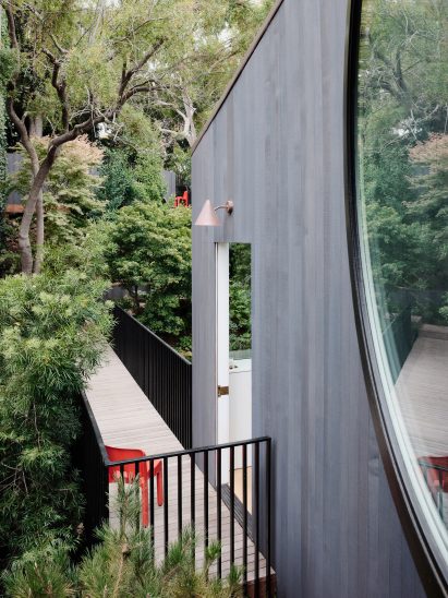 Blackened facade featuring a circular pivot window