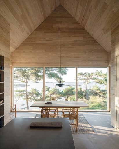 Dining table in front of window in house of offcuts by Kolman Boye Architects