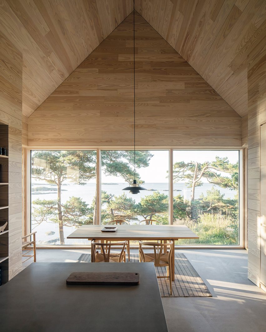 Dining table in front of window in House of offcuts by Kolman Boye Architects