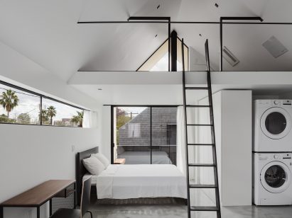 Minimalist interior design within white apartment with gabled roof in Arizona
