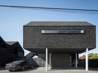 Asphalt shingles clad the exterior walls of the bungalows
