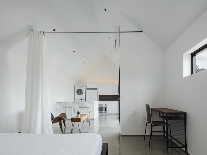 Tall white curtain in sleeping area of apartment