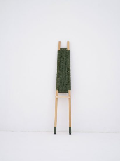A market stool with green upholstery