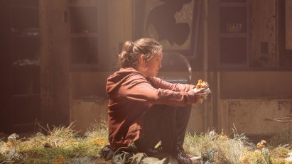 Ellie sitting on an overgrown floor in The Last of Us