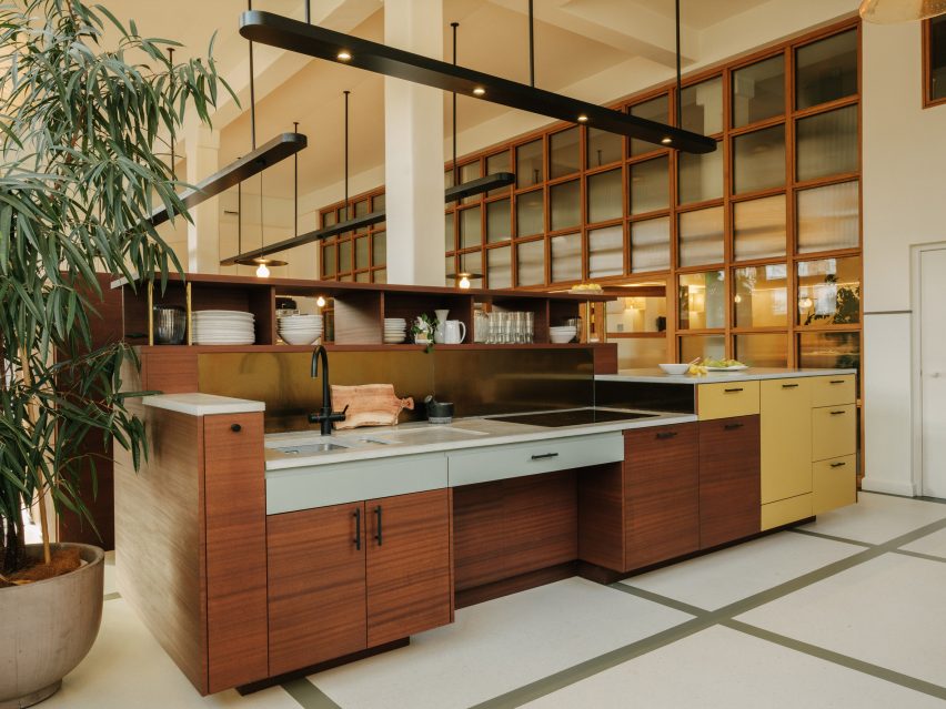 Modular kitchen island in a double-height space with overhead pendant lighting