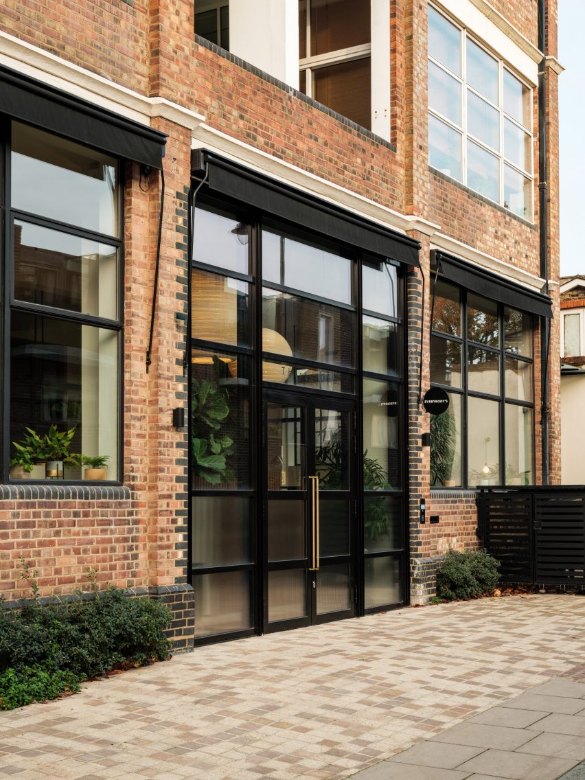 Brick industrial buiilding with large windows and glass doors in metal frames