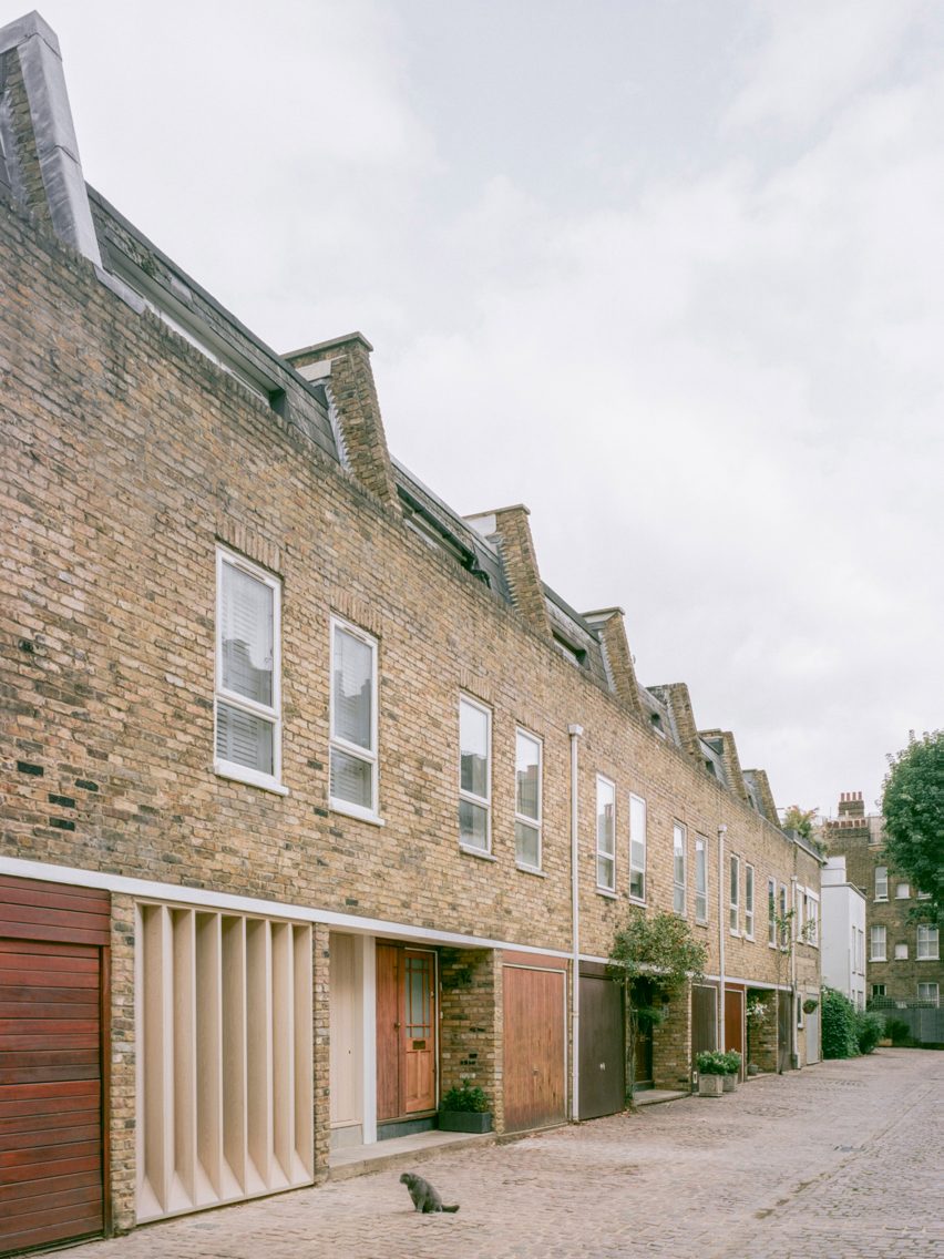 Exterior of a terrace of mews houses in London with bespoke timber louvres designed by Trewhela Williams