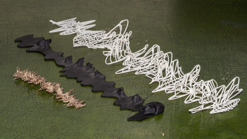 Photo of three 3D-printed complex abstract objects. On the left a small, delicate-looking silver alloy piece, then a more robust black nylon piece, and then on the right a larger white piece in interwoven nylon