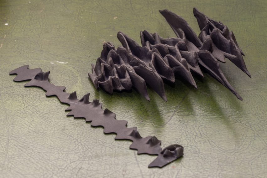 Photo of two 3D-printed abstract objects in black rubber-like material