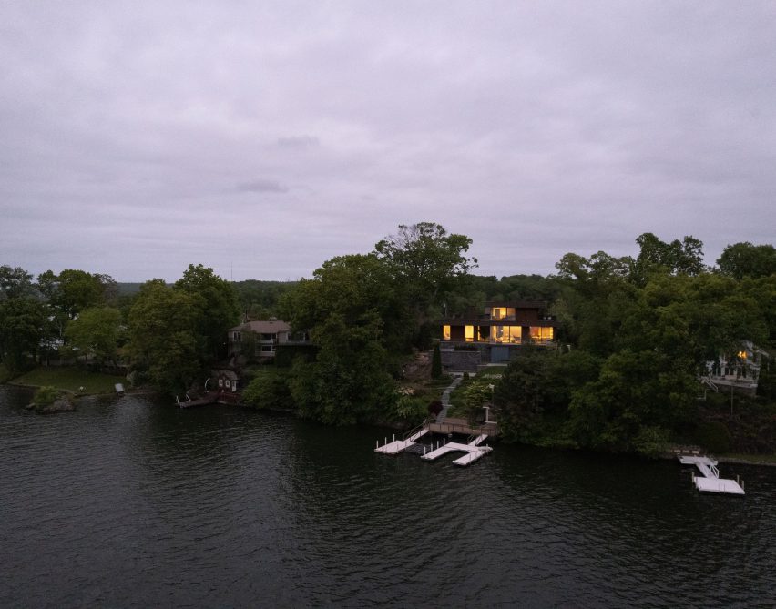 Houses among trees with steps leading down to a lake