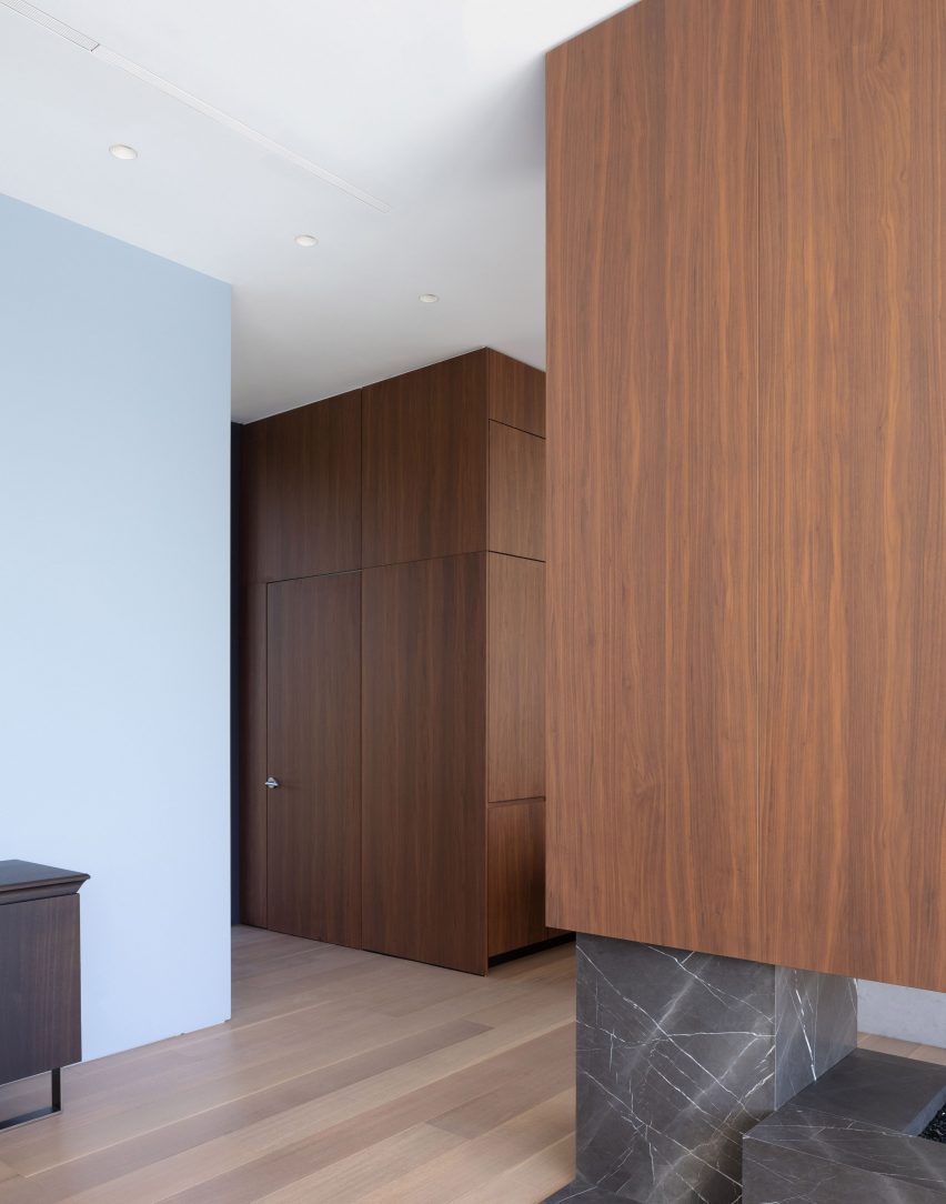 Home interior with wooden flooring and walls covered with walnut wall panelling