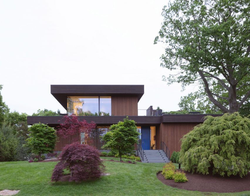 Exterior of the timber-clad lake house in Connecticut by Worrell Yeung