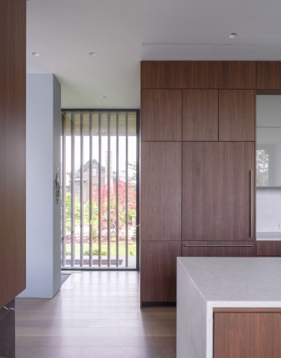 Interior of a kitchen with walnut cabinets and quartzite worktops