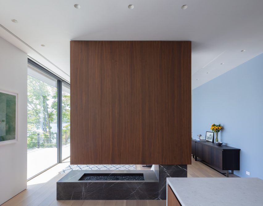 Home interior with stone fireplace and walnut-clad extractor