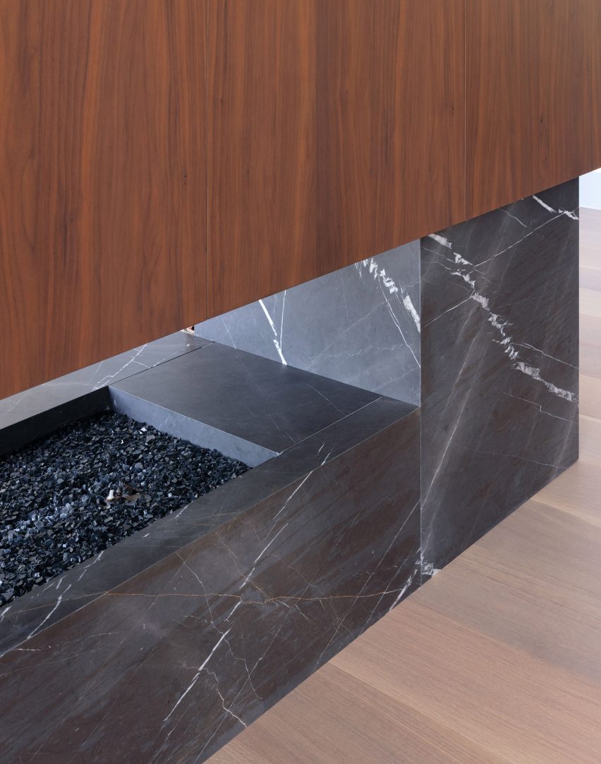 Close-up of a stone and walnut fireplace