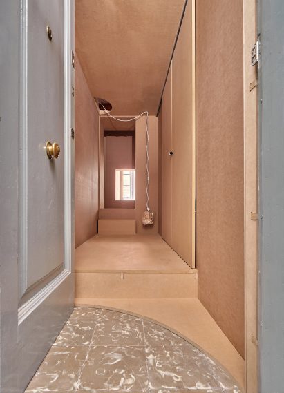 Wood-clad entrance to low-cost Barcelona apartment