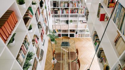 White bookshelves inside House 6 in Spain