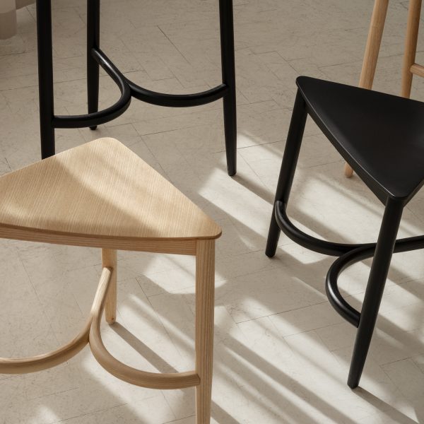 Three wooden stools on neutral coloured floor