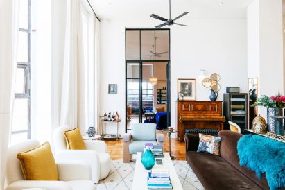 Living room featuring white walls and jewel-coloured accessories