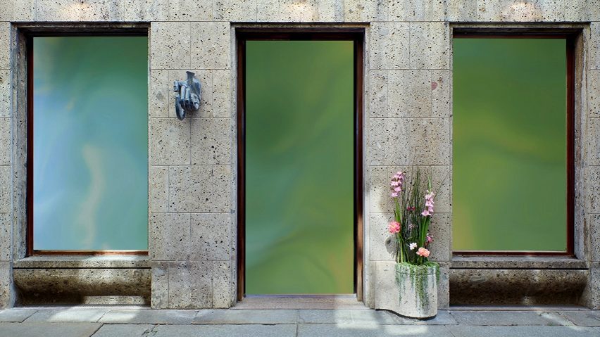 Photo of a building with green windows and flowers