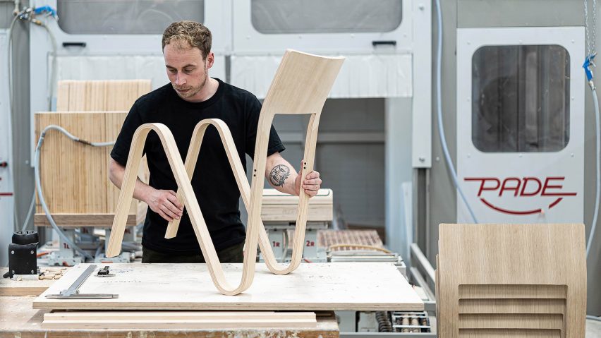 Photo of a person with a wooden chair