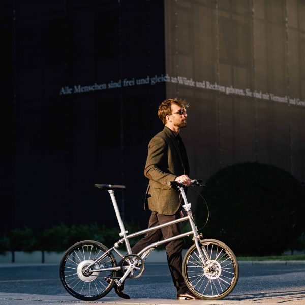 Photo of a person pushing a Vello bike