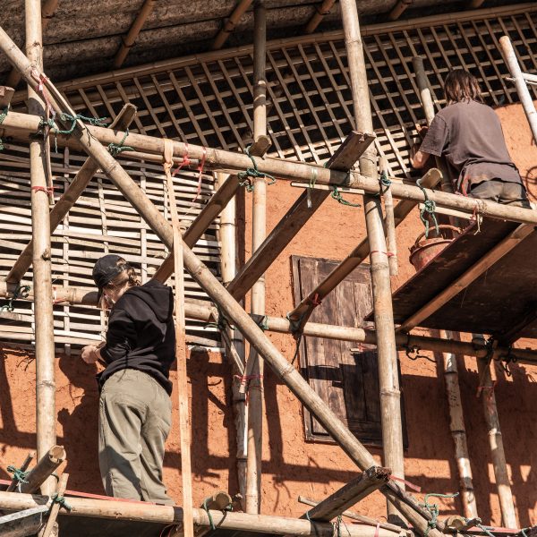 two students building the facade of an old building