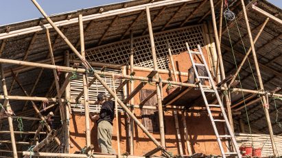 two students building the facade of an old building