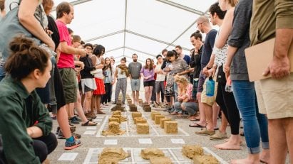 University of Arts Linz students in a tent gathered around material samples