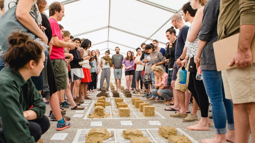 University of Arts Linz students in a tent gathered around material samples