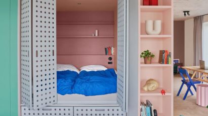 Perforated steel doors open onto cupboard bed in Domus Houthaven apartment