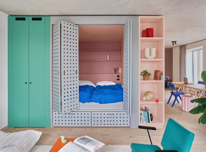 Perforated steel doors open onto cupboard bed in Domus Houthaven apartment
