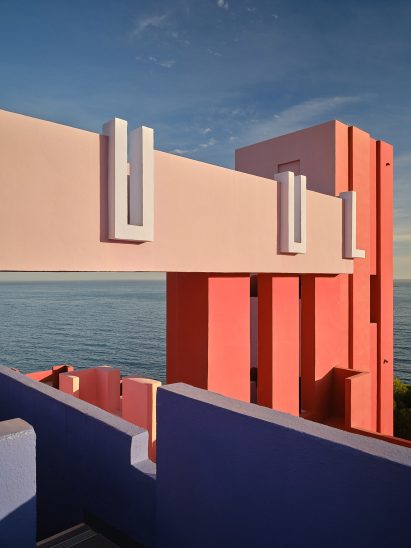 Pink walkway leading to tower with ocean in the background