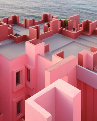 Pink stepped roof with ocean in background
