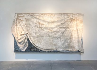 A painting on a white wall covered in white fabric