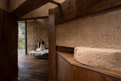 Bathroom with cob walls and wooden cabinets