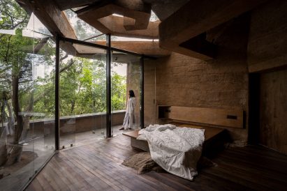 Bedroom with glazed opening and cob walls