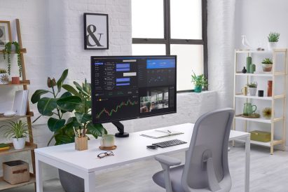 Black rectilinear screen held up by dark-hued Flo X monitor arm
