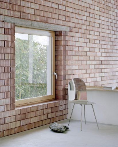 Metallic chair next to a window in Spanish house by Mesura