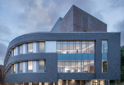 Top two storeys of a slate-clad building and large windows