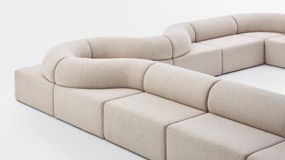 Long beige sofa on white backdrop