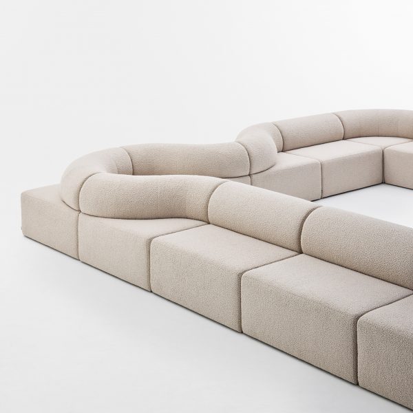 Long beige sofa on white backdrop