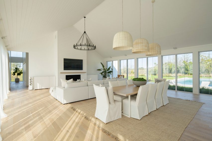 Open-plan living room with timber floors and white walls