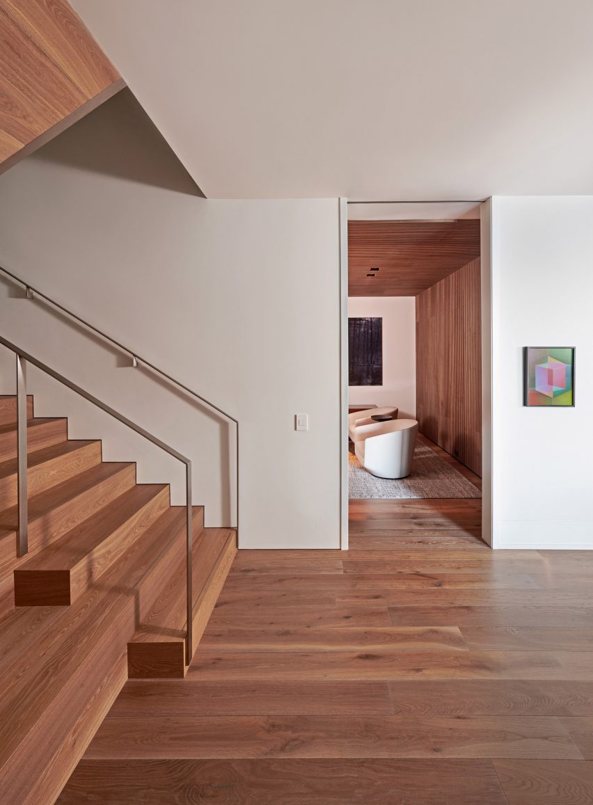 Interior entryway with white walls, oak flooring and oak staircase