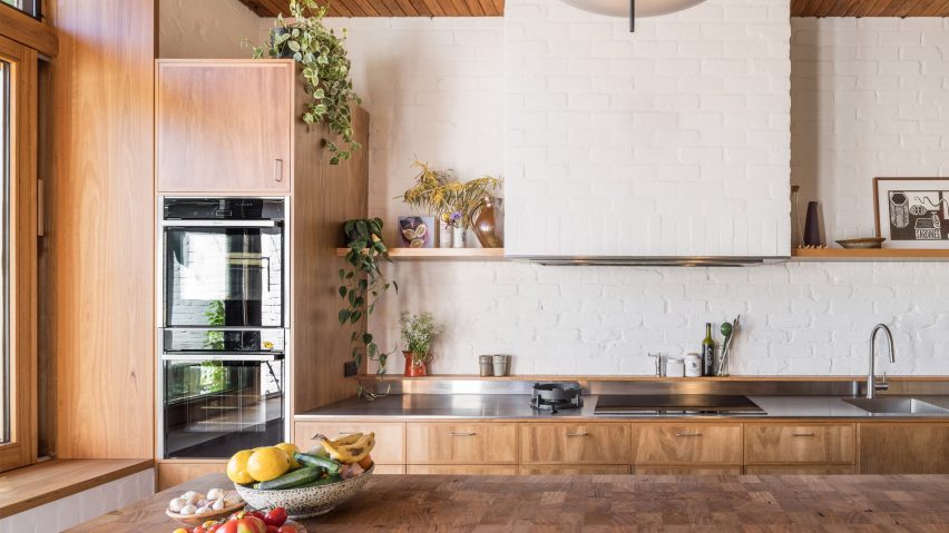 Kitchen with white brick walls and wood cabinets